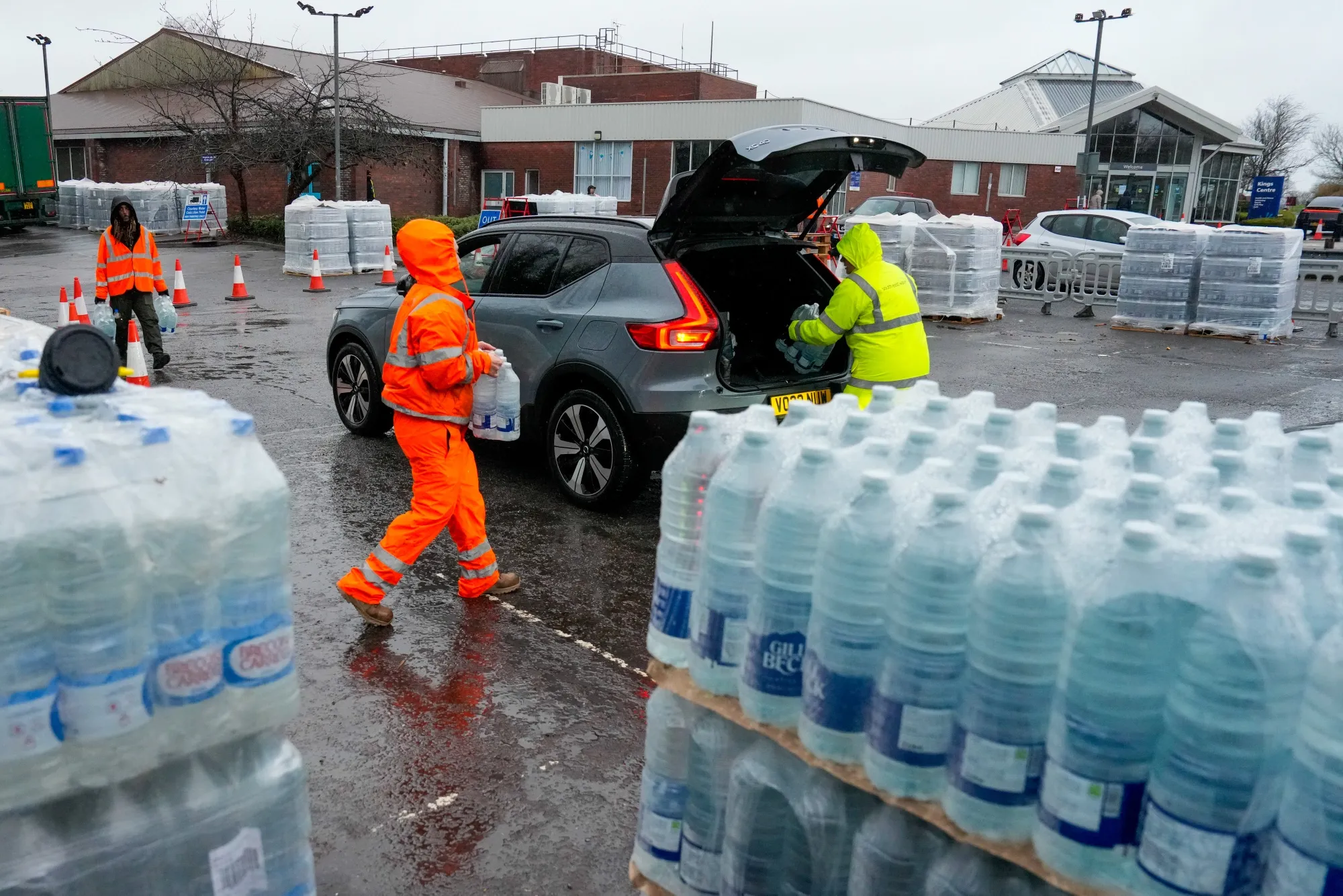 Volunteers distribute bottles of water at a collection point in East Grinstead, on Jan. 13.