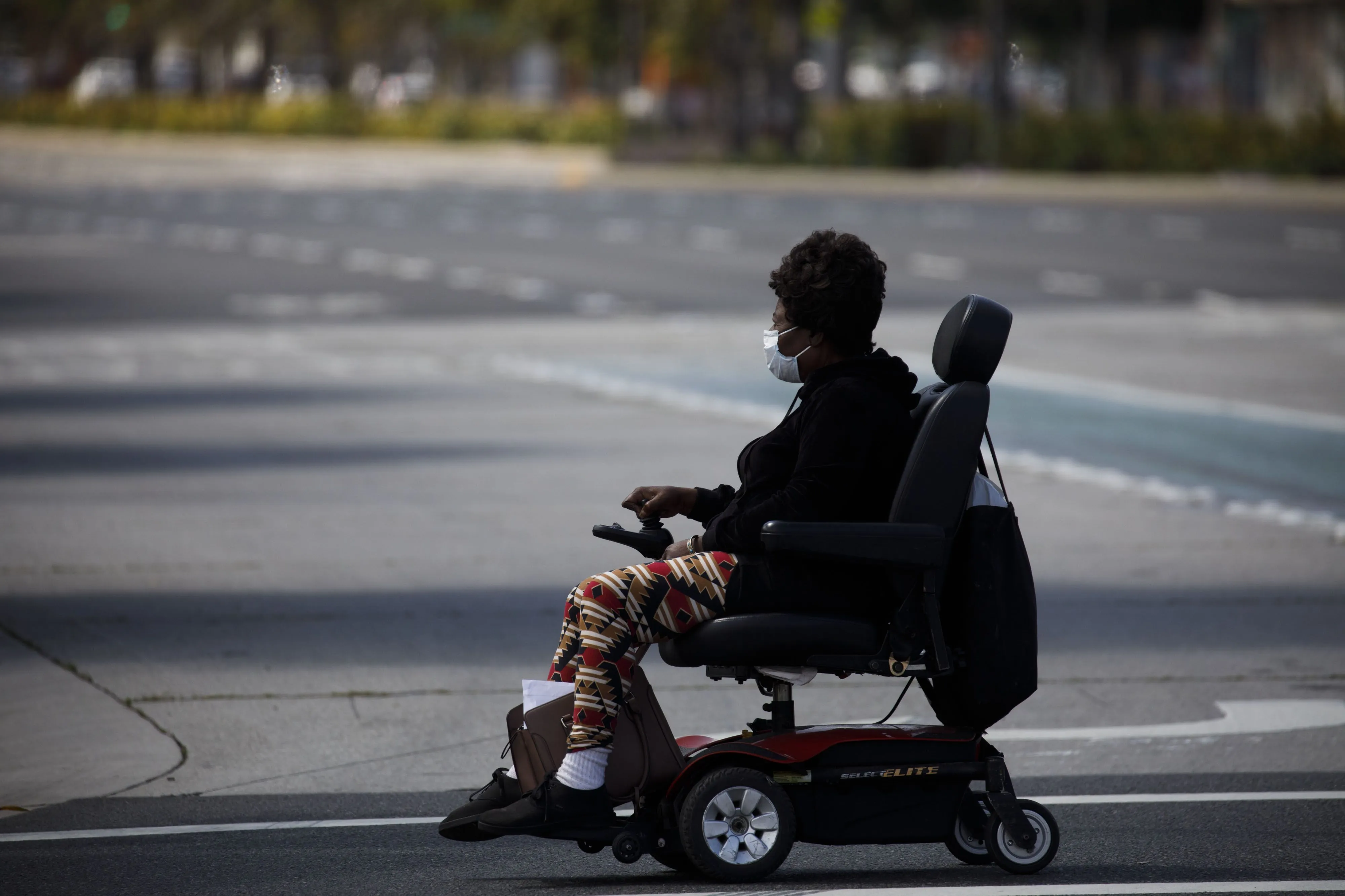A person in an electric wheelchair crosses a street in&nbsp;Hawthorne, California. Adding bike infrastructure is a boon for cyclists, but some street redesigns can make getting around harder for&nbsp;disabled road users.&nbsp;