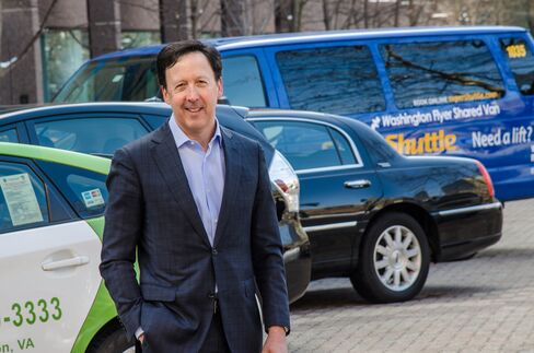 Mark Joseph, CEO of Transdev North America, with vehicles representing the On Demand division of the company, including taxi, ExecuCar, and SuperShuttle.