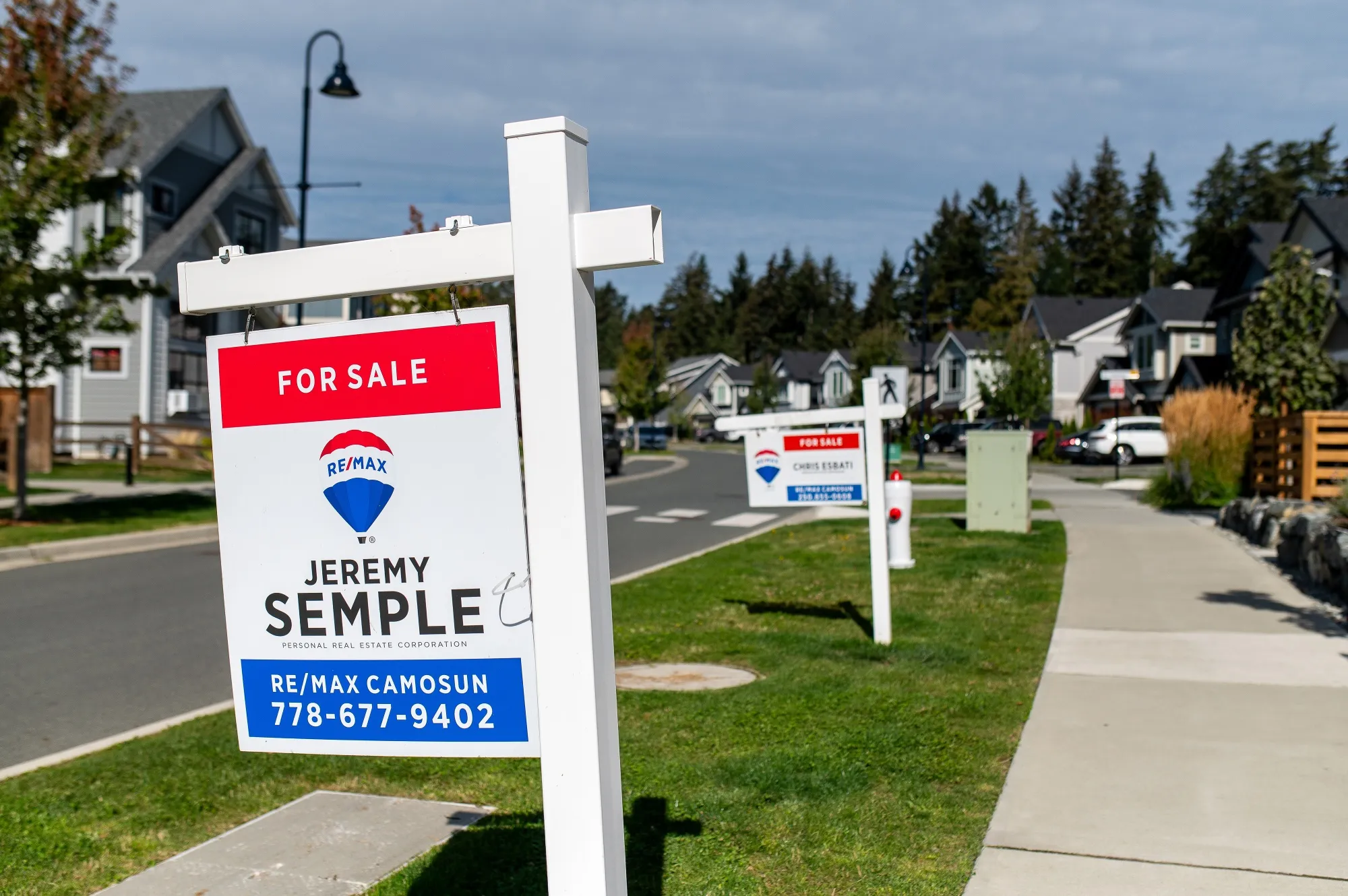 "For Sale" signs in Colwood, British Columbia, Canada.