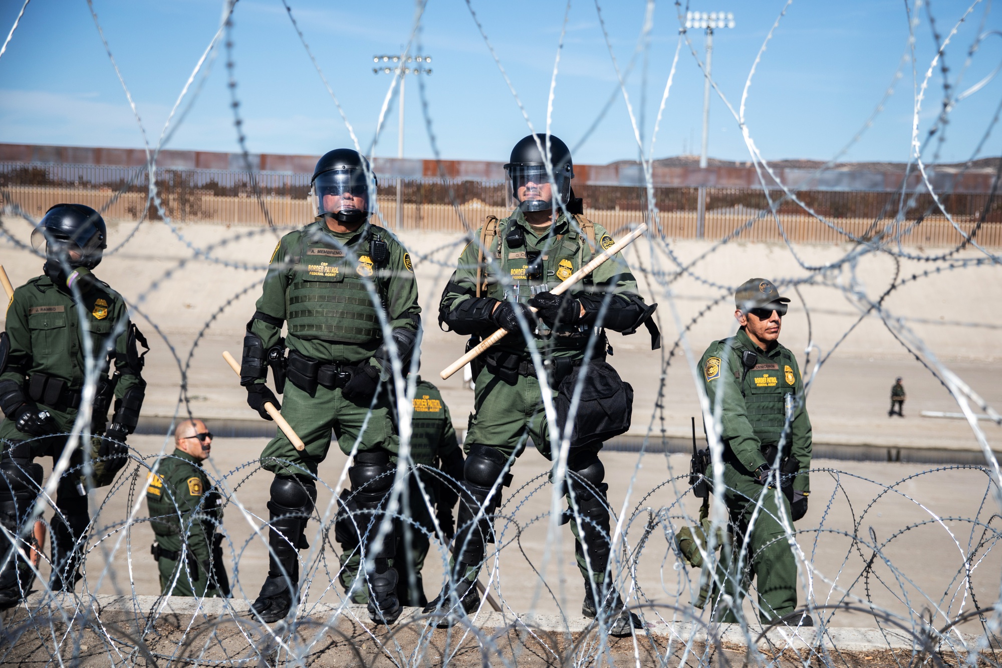 U.S. Customs and Border Protection (CBP) officers stand guard along the US and Mexico border.