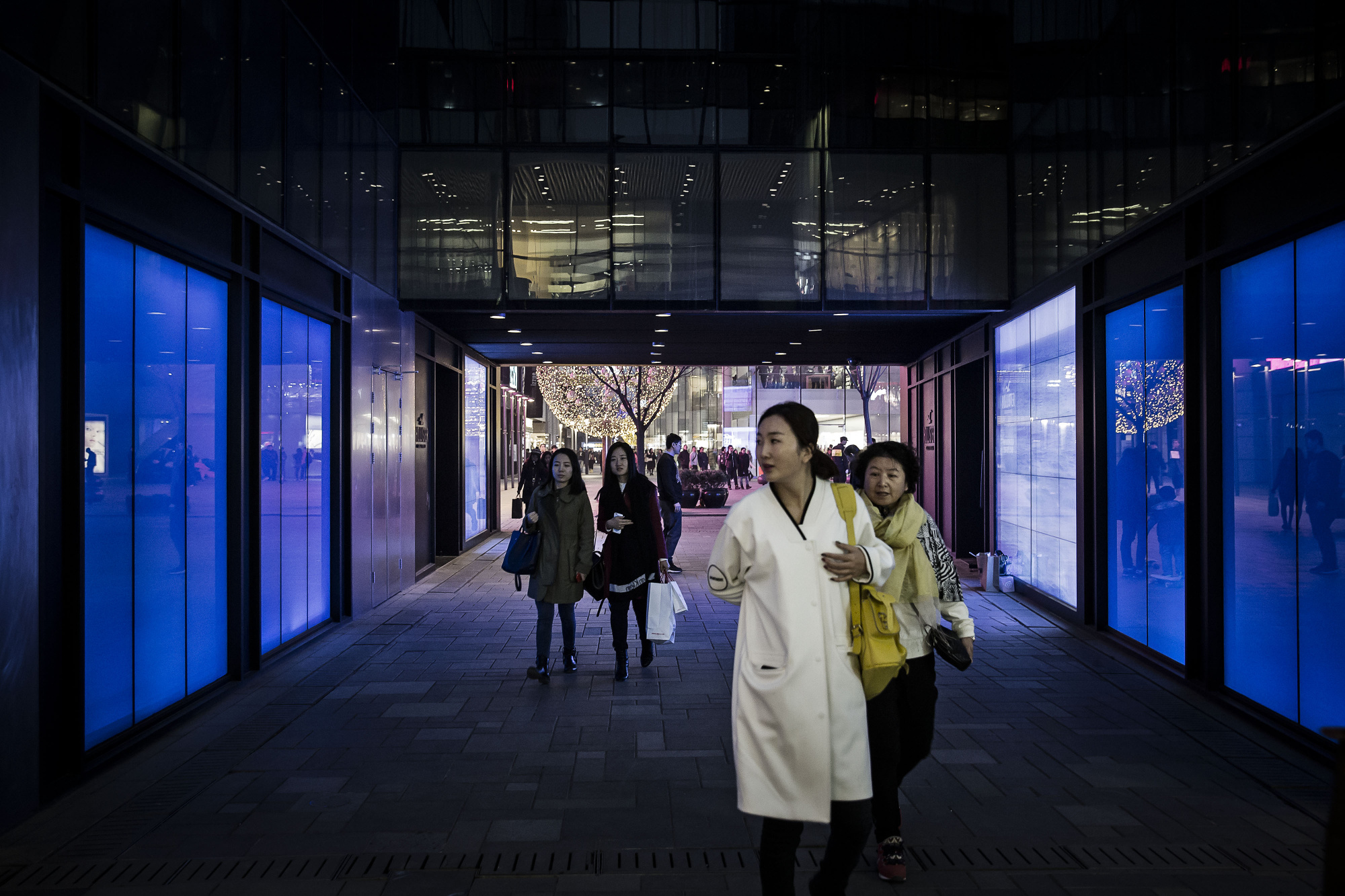 Shoppers walk through an open air shopping mall in Beijing, China.
