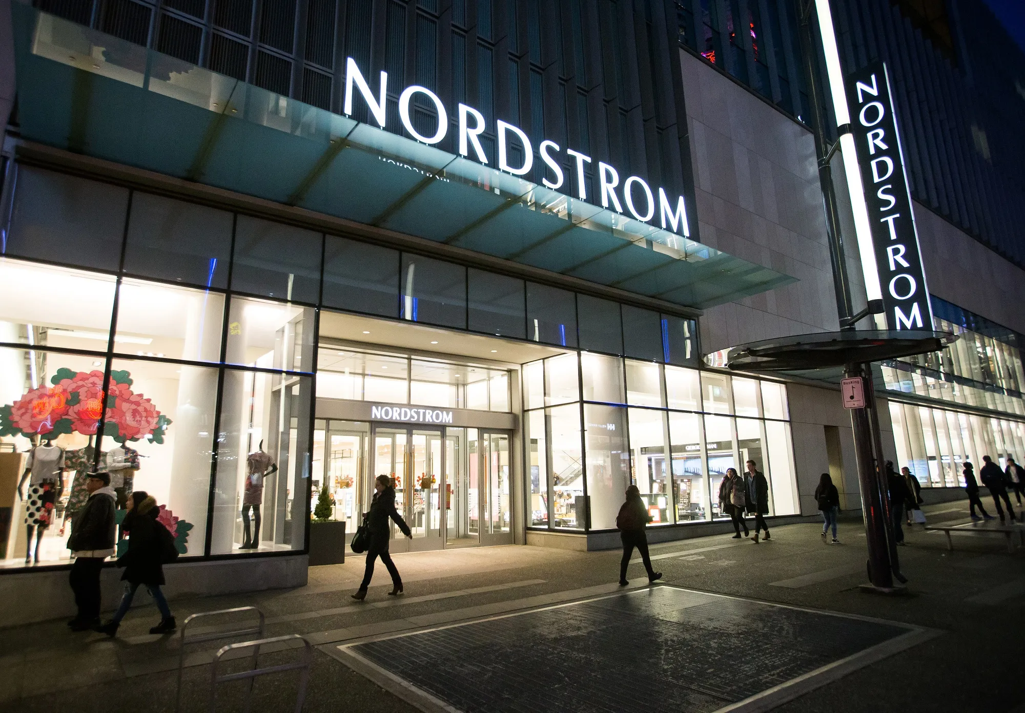 Pedestrians walk past a Nordstrom Inc. store in downtown Vancouver.