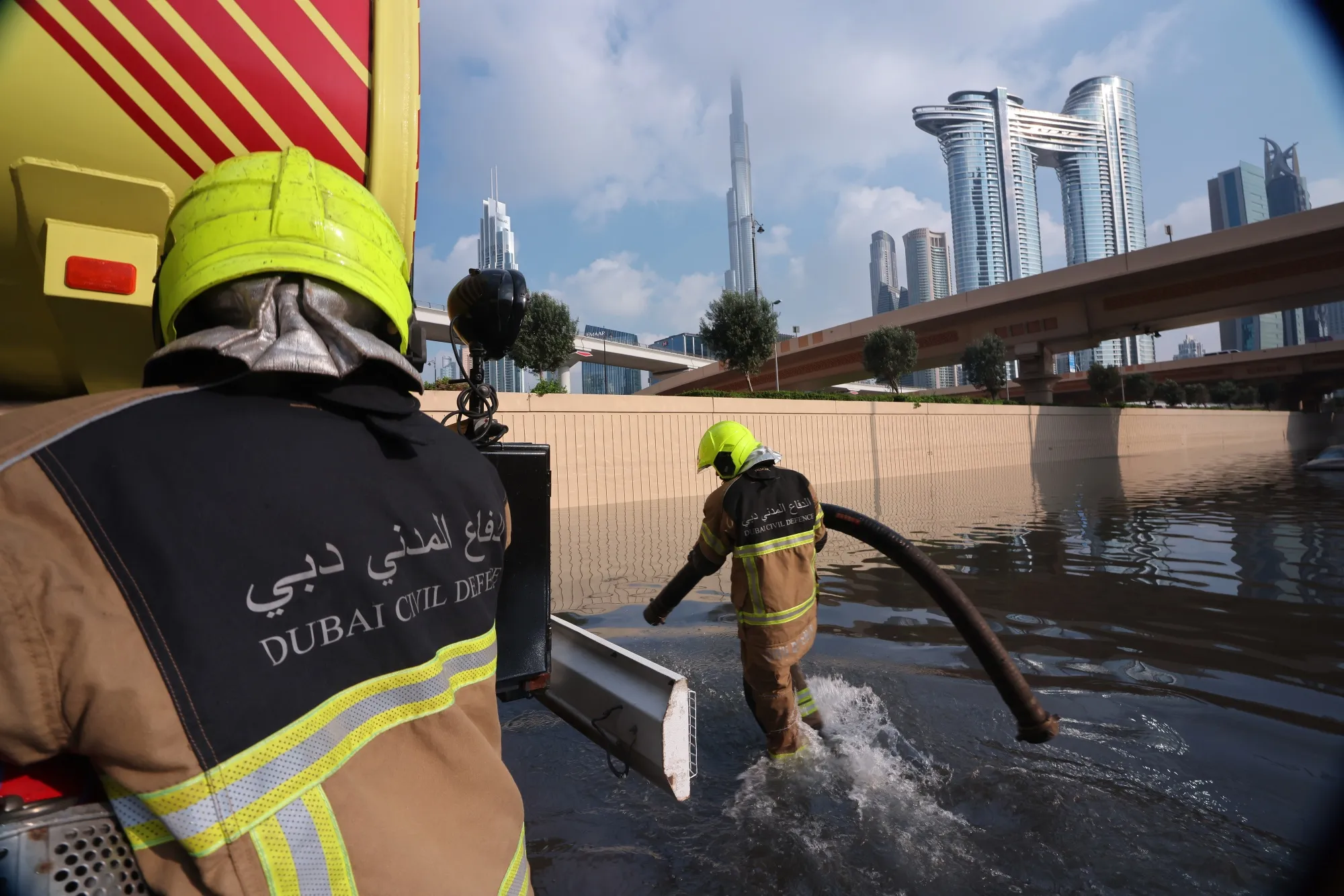 Members of the Dubai Civil Defence prepare to remove water from a flooded highway after a rainstorm in Dubai on April 17.