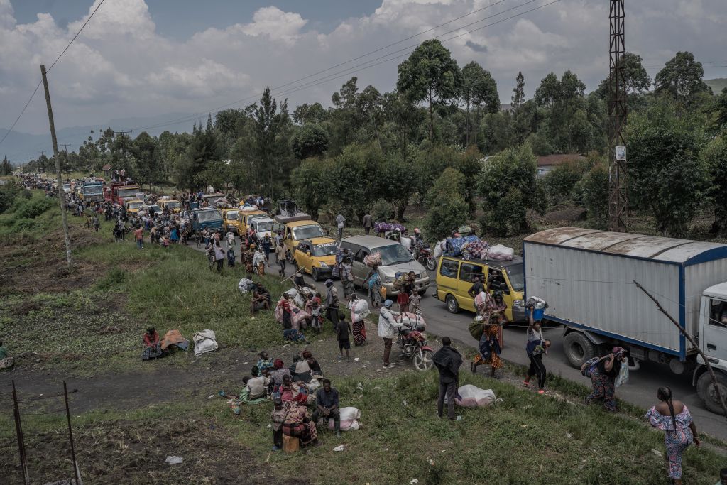 People flee the Masisi territory following clashes between M23 rebels and government forces, at a road near Sake.