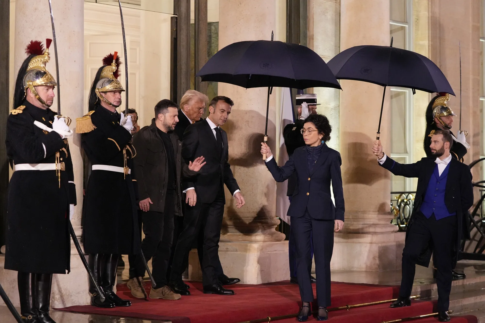 Volodymyr Zelenskiy, Emmanuel Macron and US president-elect Donald Trump at the Elysee Palace.