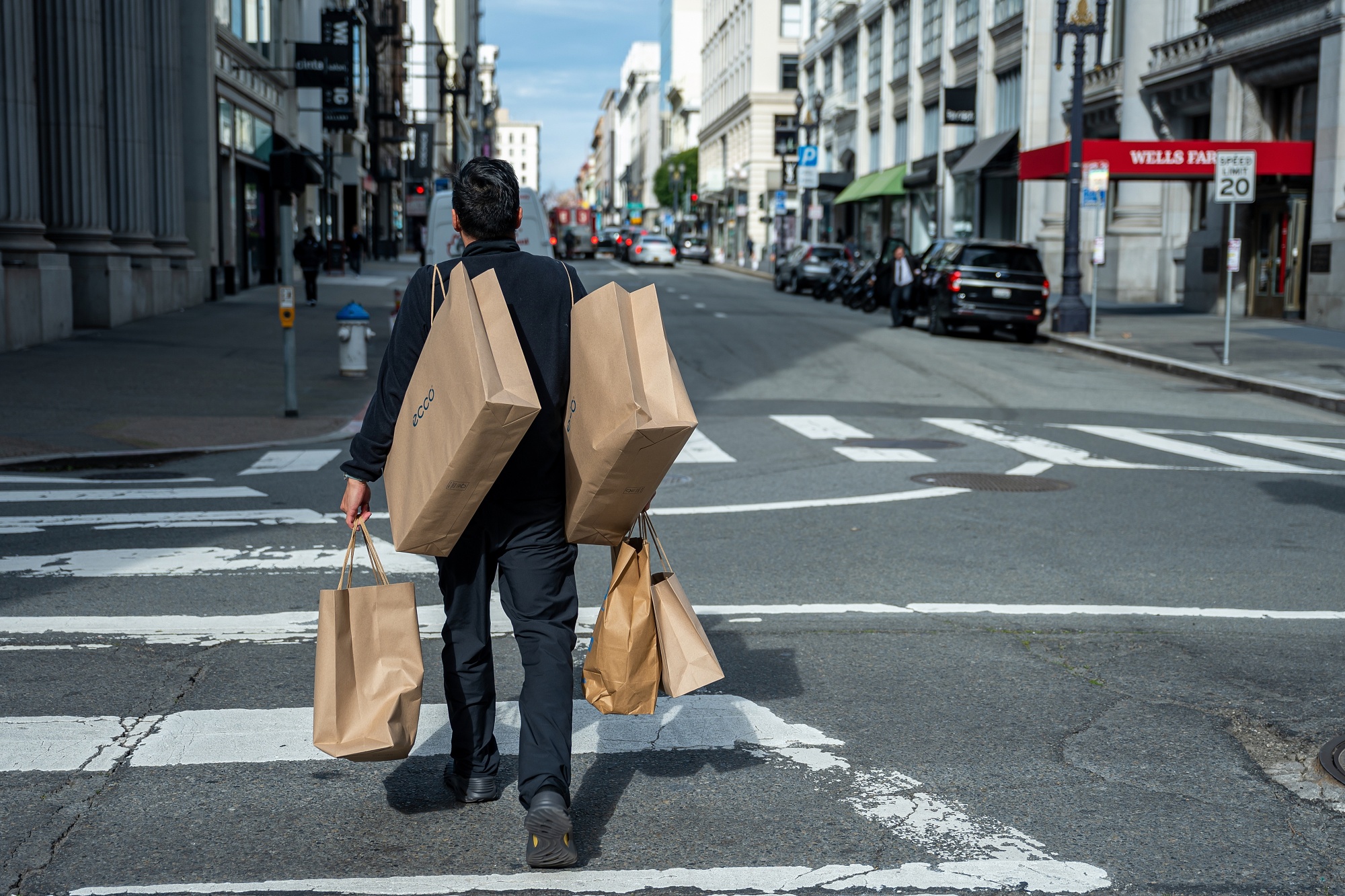 A shopper carries bags in the Union Square neighborhood of San Francisco.
