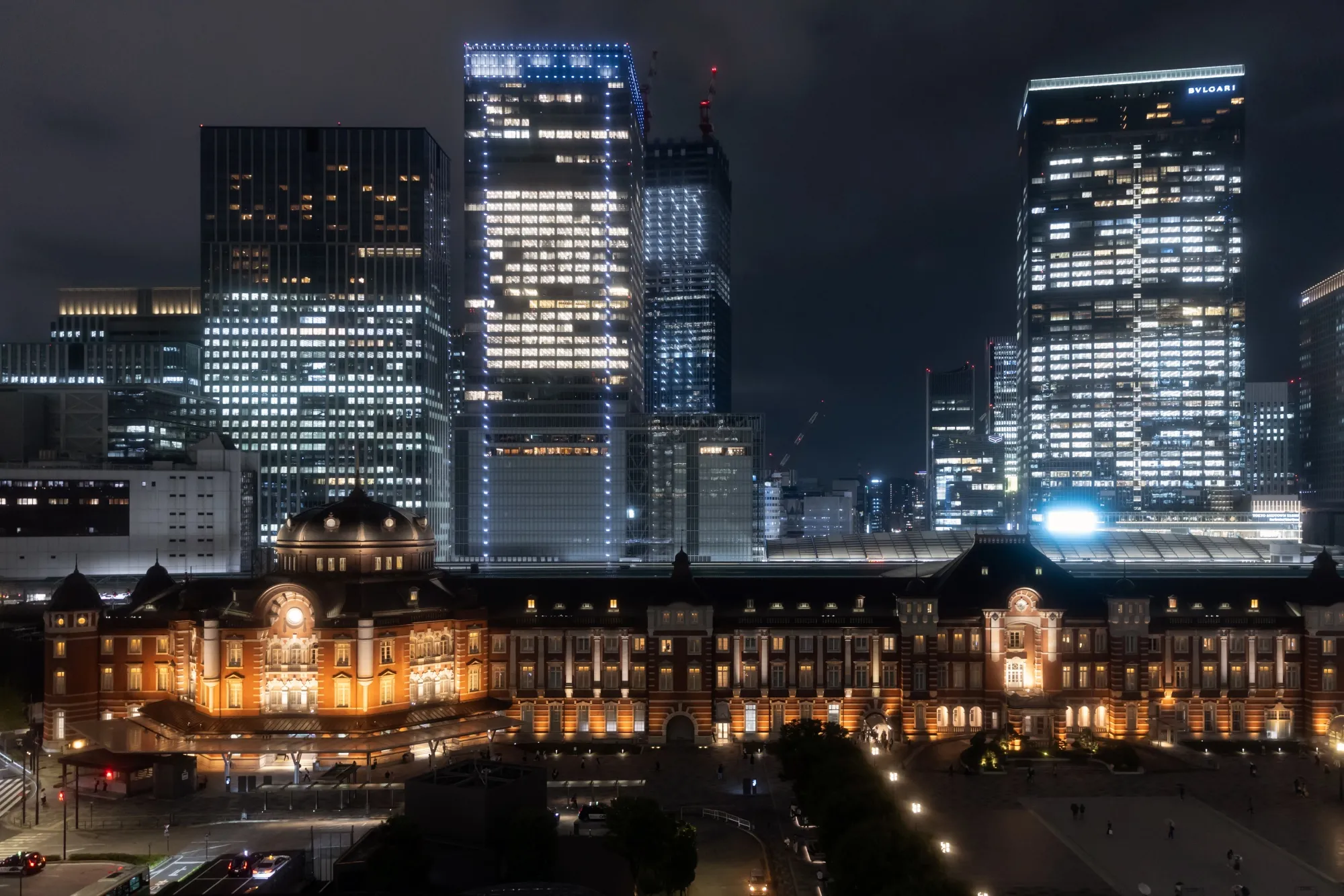 Tokyo station and commercial buildings at night in Tokyo.
