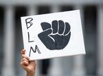 A demonstrator holds a Black Lives Matters sign during a protest against racism at the statehouse on June 6, 2020 in Columbia, South Carolina.