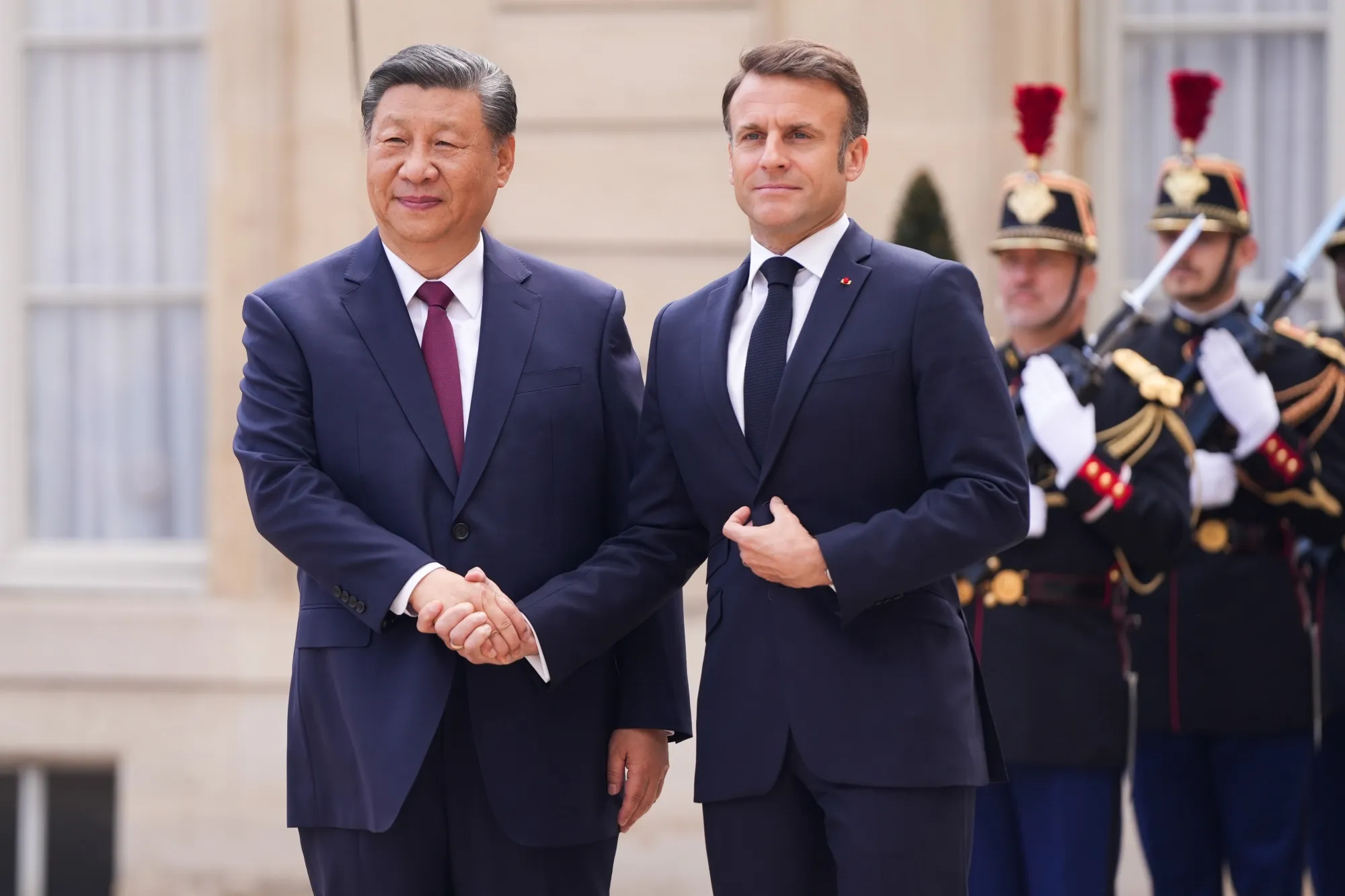 Emmanuel Macron, right, greets Xi Jinping in Paris, France&nbsp;on Monday.&nbsp;