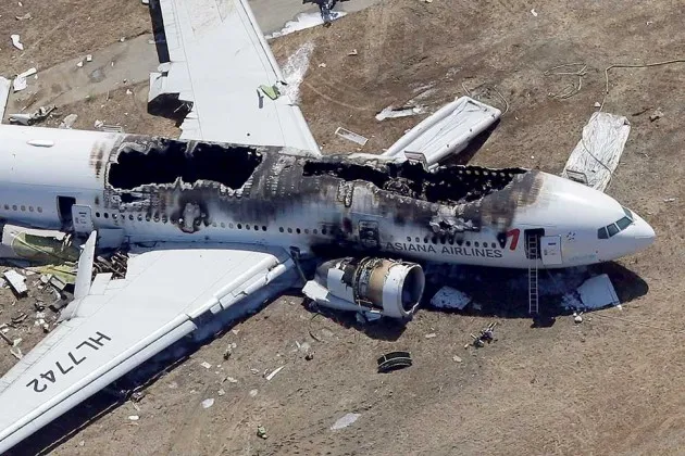 Asiana Flight 214 lies burned near the runway after it crash landed at San Francisco International Airport on July 6, 2013 in San Francisco