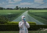 A health worker wears a protective suit as he takes a break at a makeshift COVID-19 testing site in Beijing.