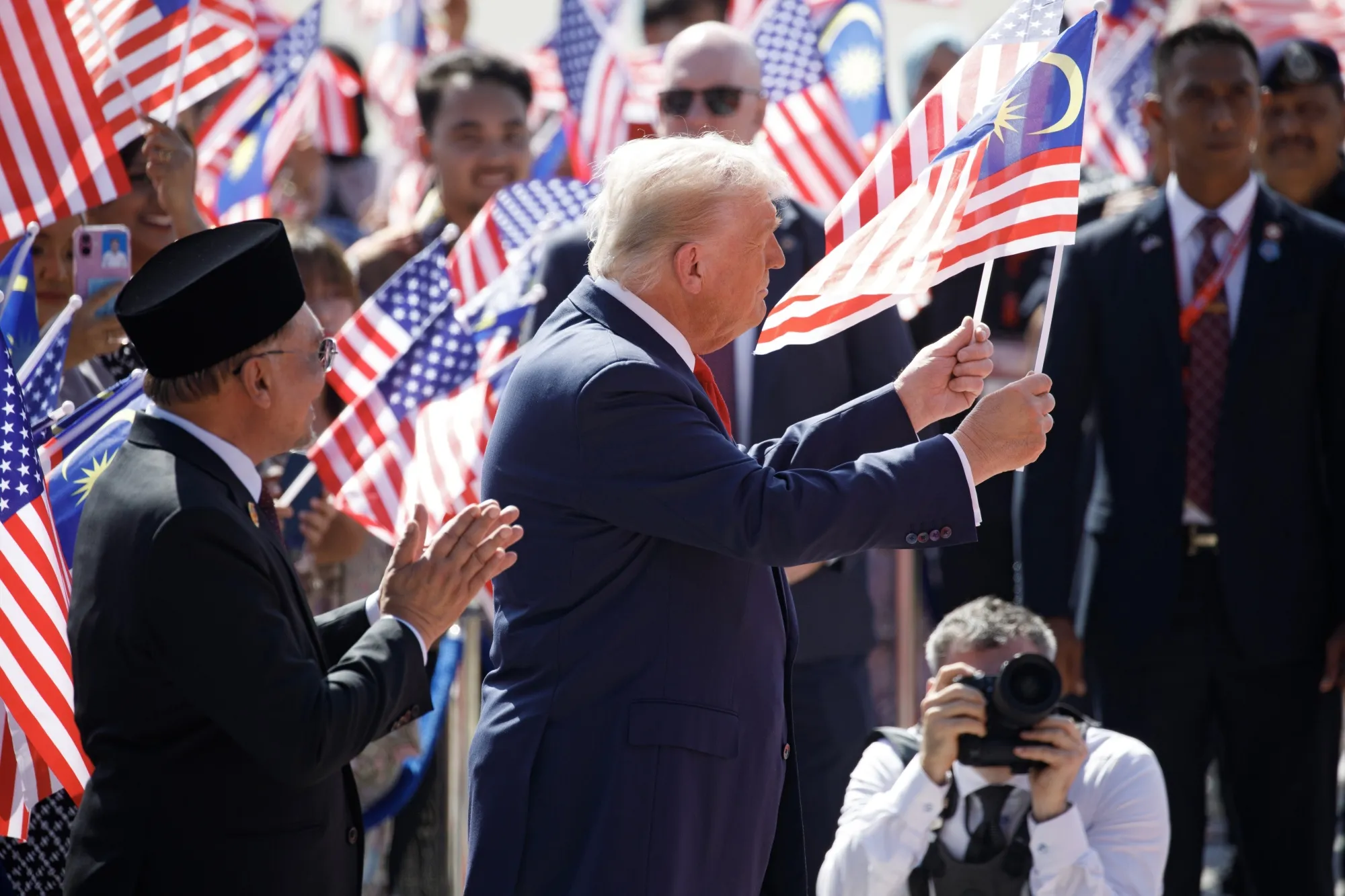 Trump waving the Stars and Strips and Malaysia’s Jalur Gemilang.