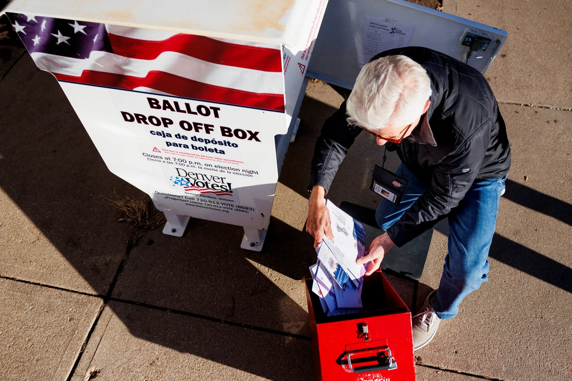 A Denver election judge collects ballots from a ballot drop off box outside La Familia Recreation Center in Denver, Colorado&nbsp;on Tuesday.