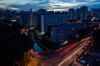 Residential and commercial buildings stand illuminated at dusk in the Kallang area of Singapore, on Saturday, Sept. 17, 2016. Singapore is currently mired in its most prolonged housing slump on record. Home prices in the city-state fell for the 11th straight quarter in the three months ending June 30, posting the longest losing streak since records started in 1975.