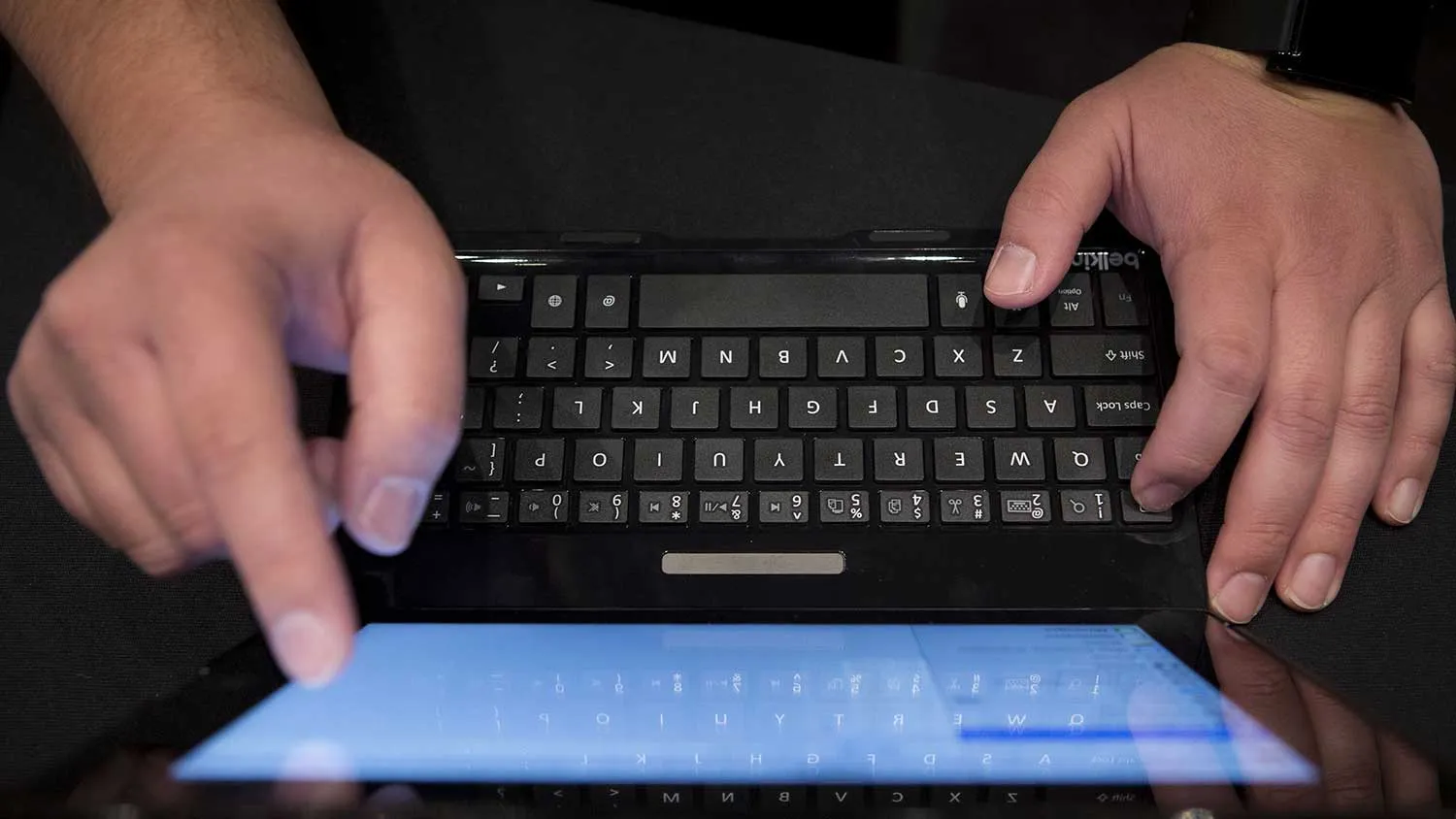 An employee types on a Belkin International Inc. "Ultimate" tablet keyboard at Pepcom DigitalFocus in New York, U.S., on Thursday, April 11, 2013.
