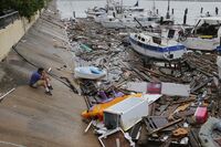 A man surveys damage to a marina after it was hit by Hurricane Hanna in Corpus Christi, Texas on July 26.