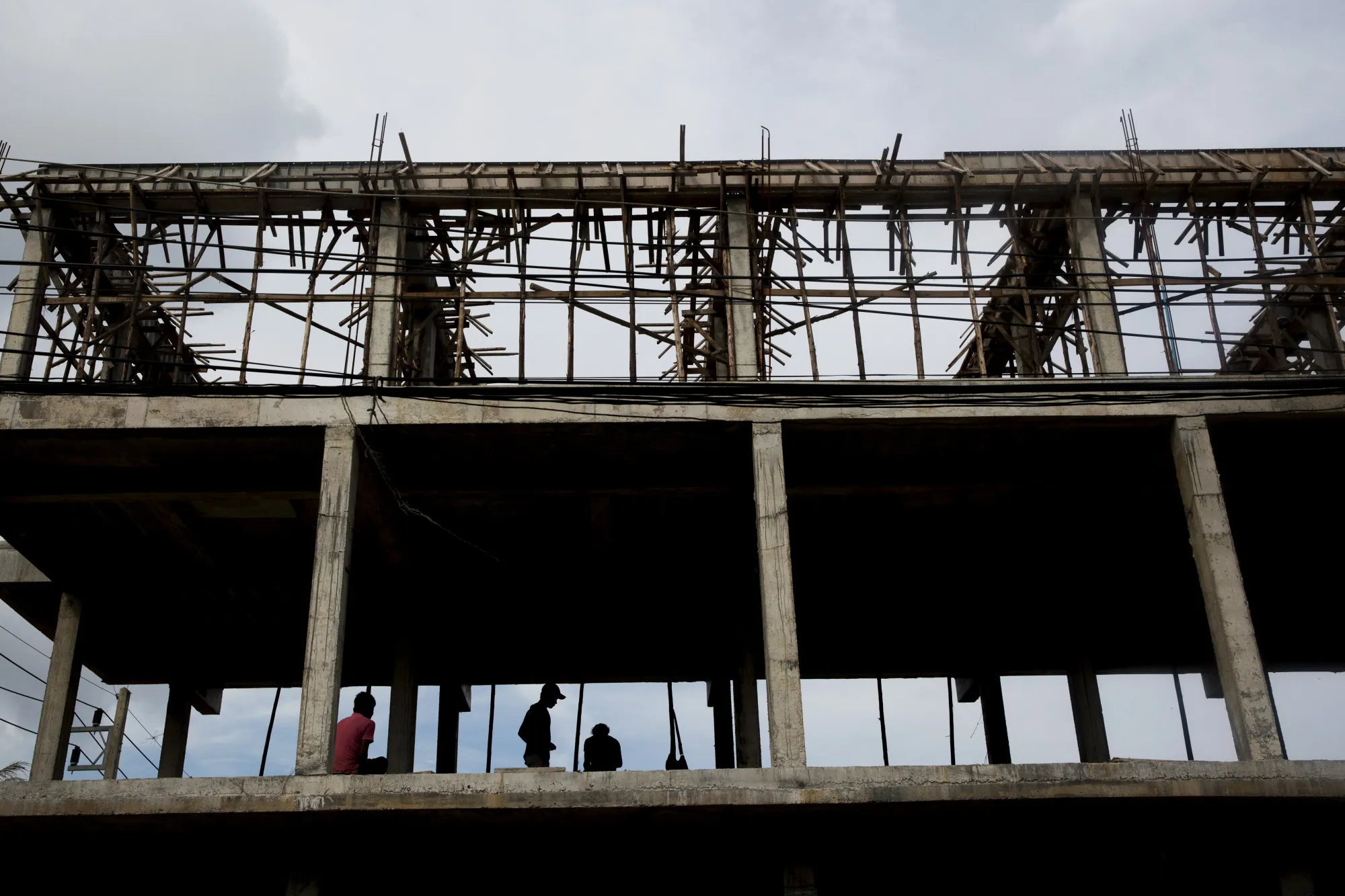 Worker sit inside a building under construction in Koh Phangan in Thailand.
