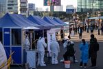 A medical worker&nbsp;collects a sample from a visitor at a temporary Covid-19 testing station outside Seoul Station in Seoul last week.