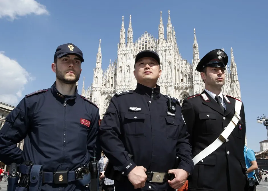 A Chinese police officer with Italian colleagues in front of Milan's cathedral.