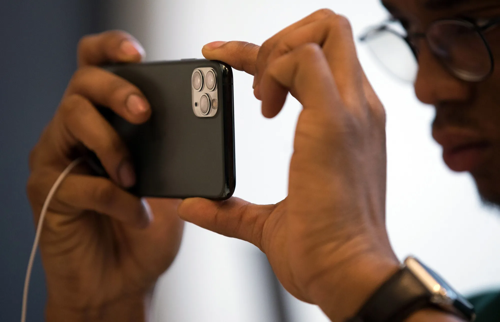 A customer takes a photograph with an Apple iPhone.