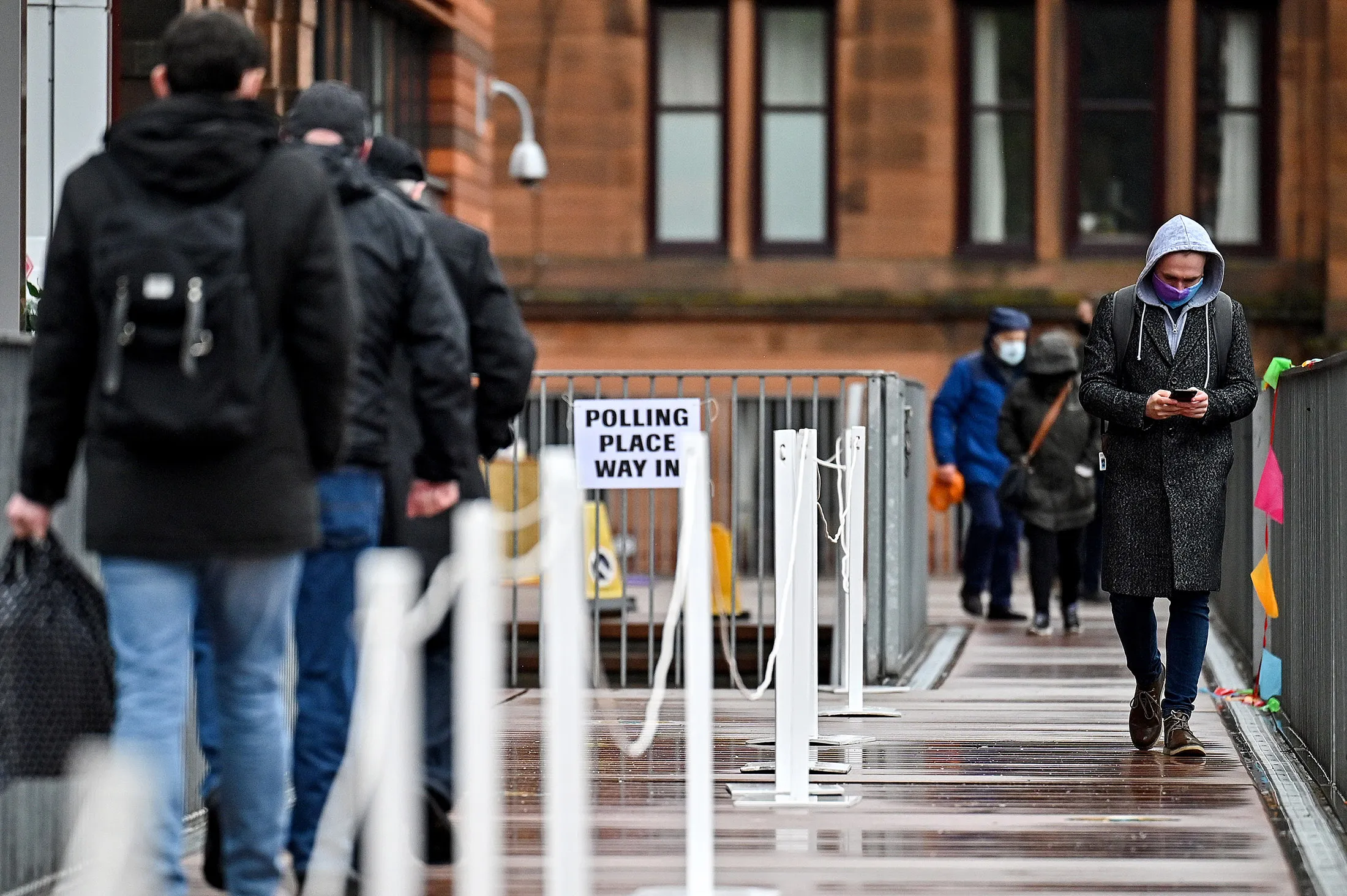 Voters leave a polling station at Notre Damme Primary School in Glasgow, Scotland on May 6.