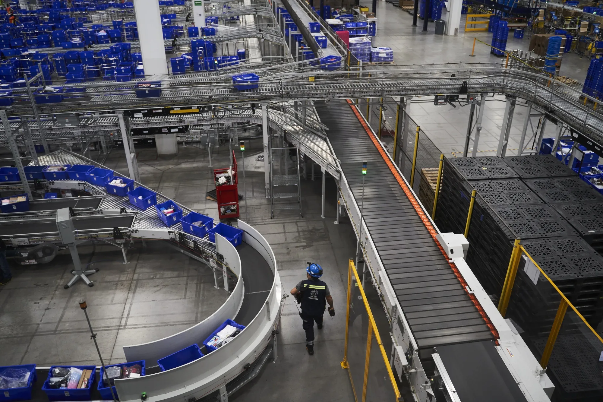 Trays of products move along a conveyor in the packaging area at the MercadoLibre Distribution Center (Cedis) at Prologis Park Grande in Tepotzotlan, Mexico state, Mexico, on Tuesday, Nov. 29, 2022. 
