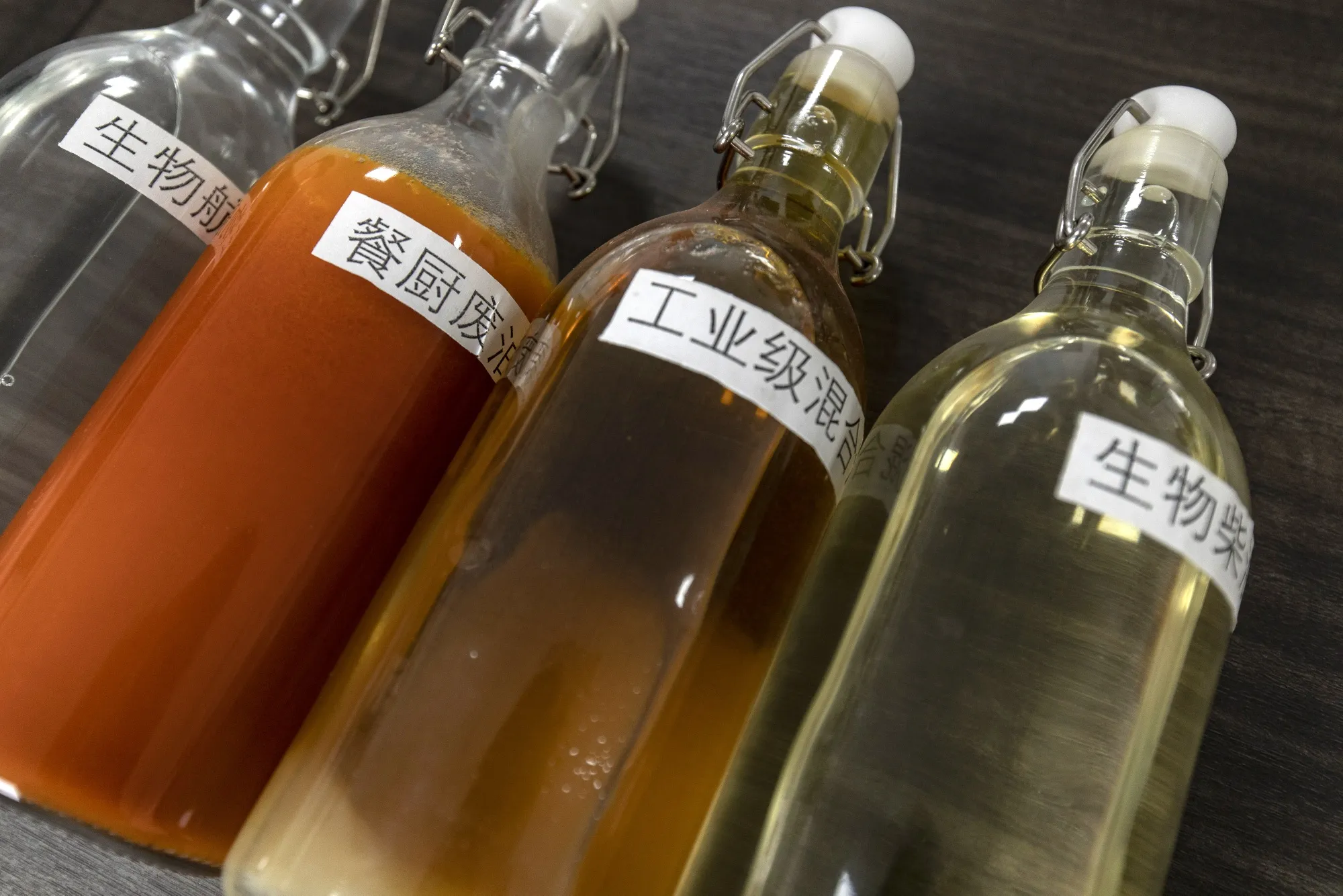 Sample bottles of aviation&nbsp;biofuel —&nbsp;including leftover grease from Sichuan hot pot —&nbsp;at a Chinese facility.