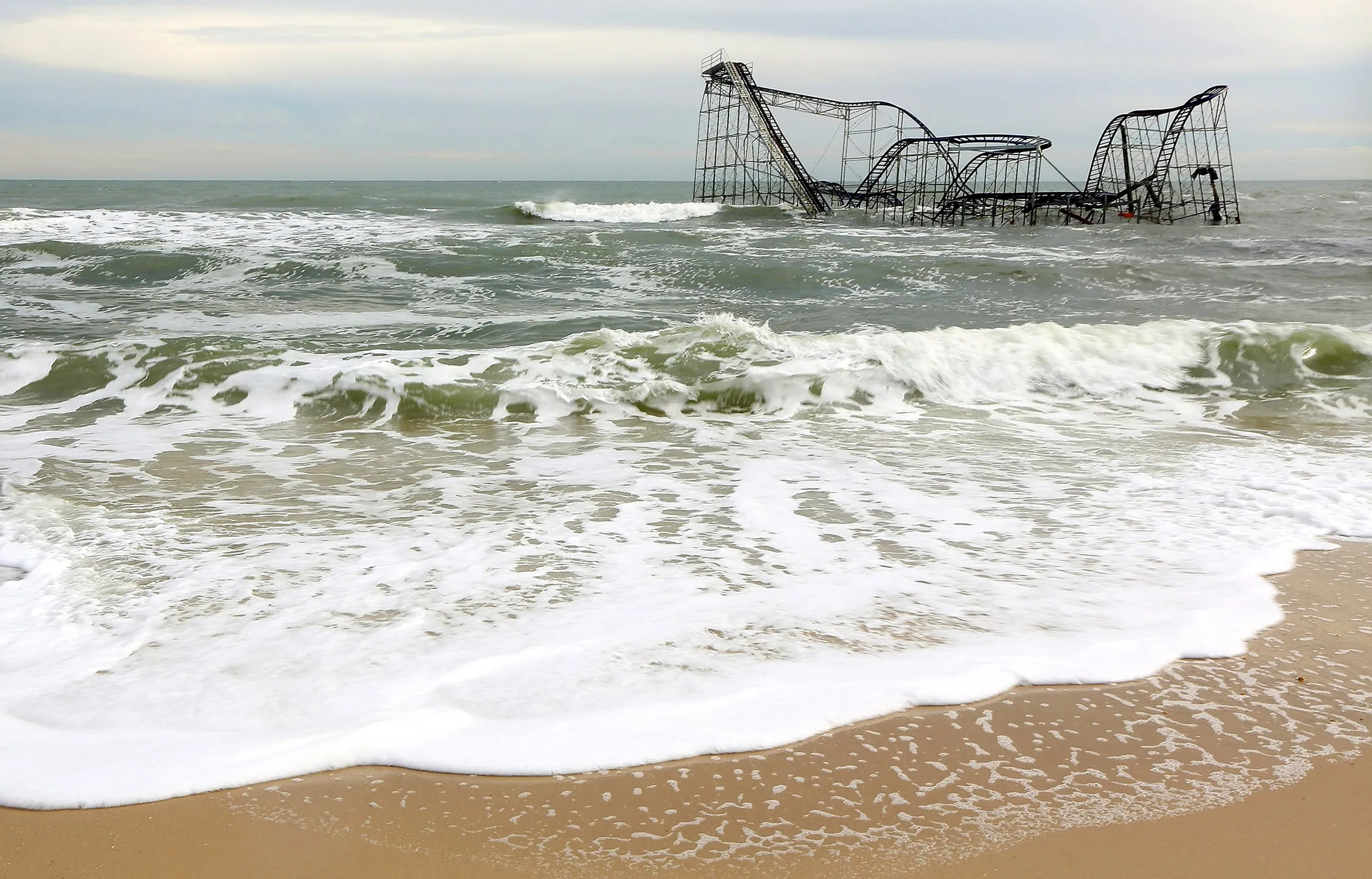 Waves break around a destroyed roller coaster in Seaside Heights, New Jersey, on Nov. 16, 2012.

