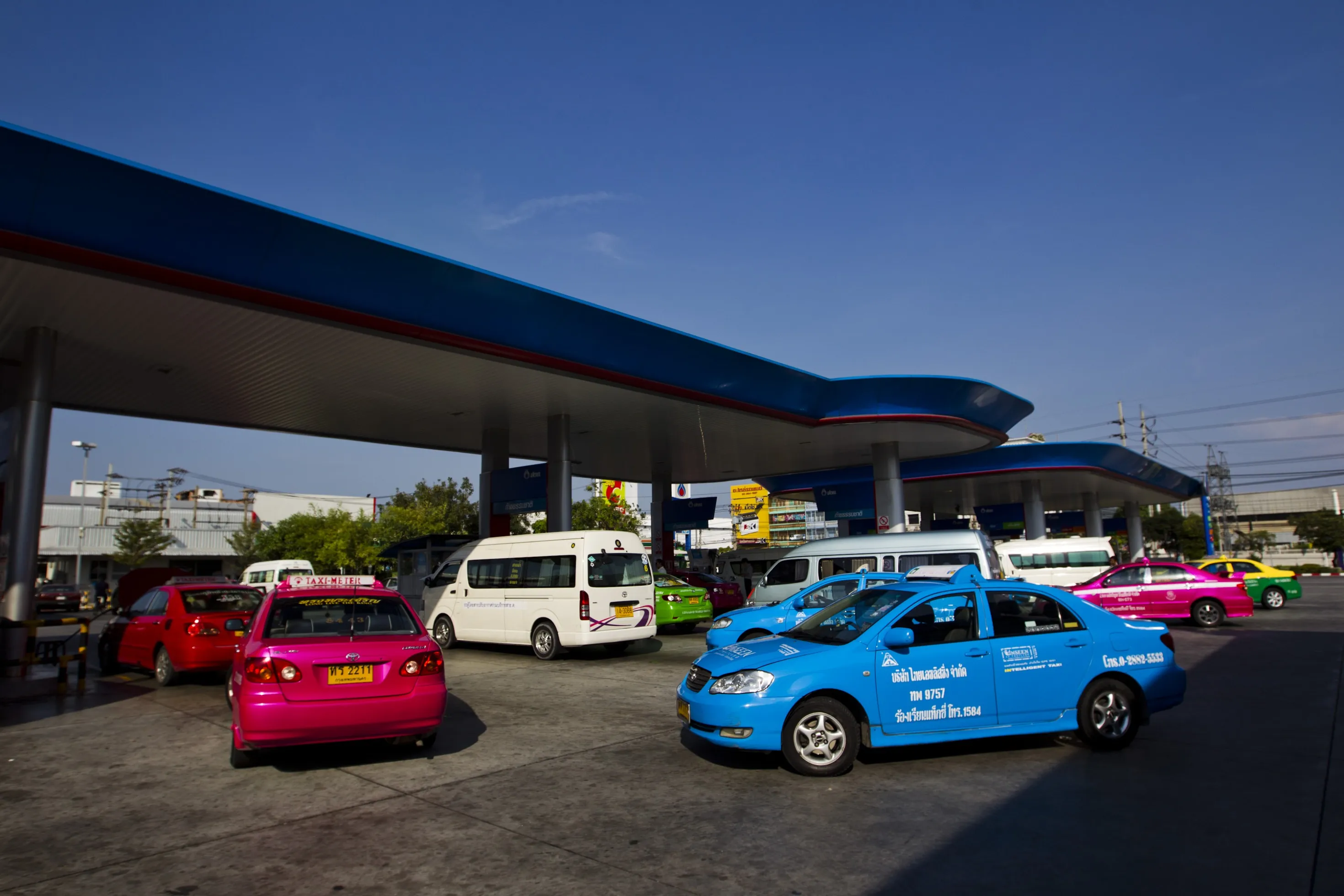Vehicles wait to fill up on gas at a gas station in Bangkok, Thailand.