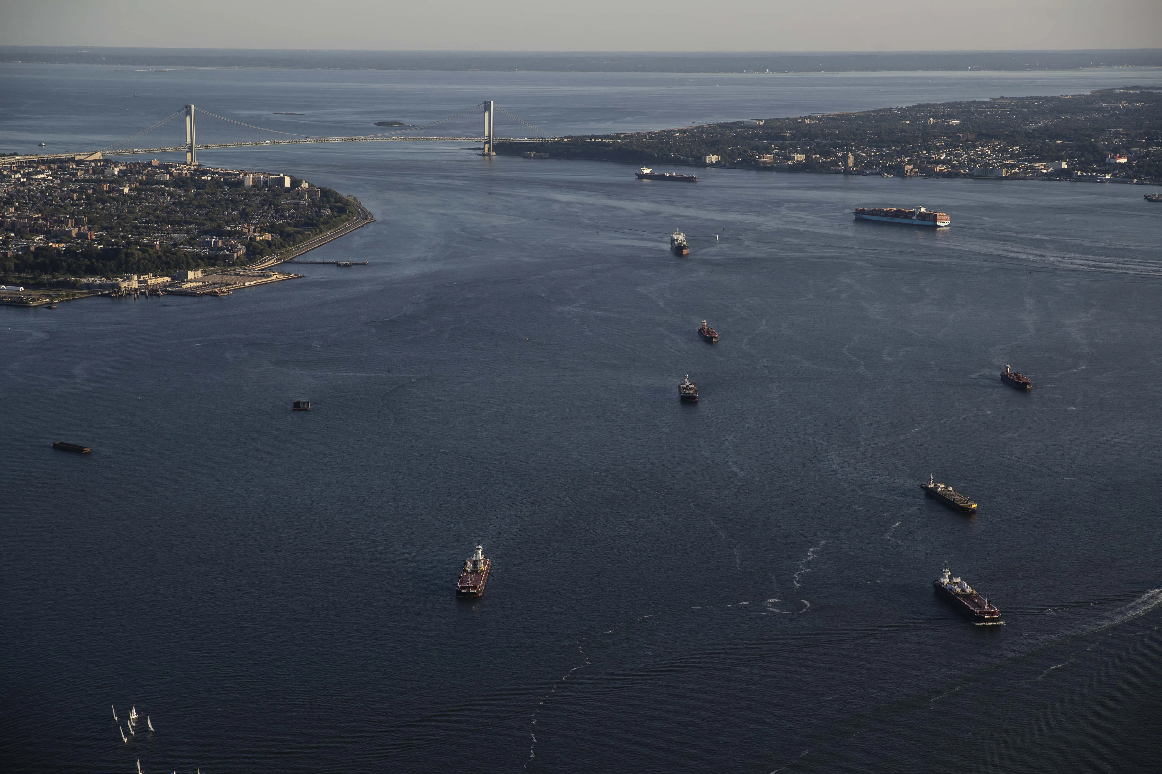 Ships travel through New York Harbor towards the Verrazzano-Narrows Bridge in New York.&nbsp;