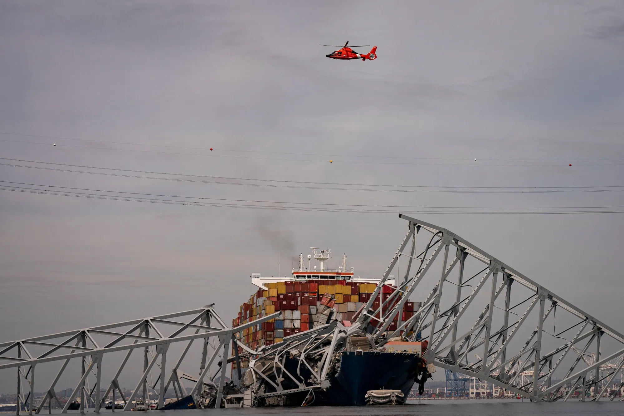 A US Coast Guard helicopter flies over the Dali container vessel after it struck the Francis Scott Key Bridge in Baltimore, Maryland on March 26.&nbsp;