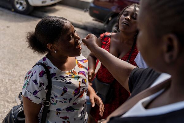 A woman receives an oral cholera vaccine in Port-au-Prince in Haiti.