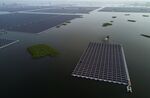 A boat pulls a group of panels to be connected to a large floating solar farm project in Huainan, China.