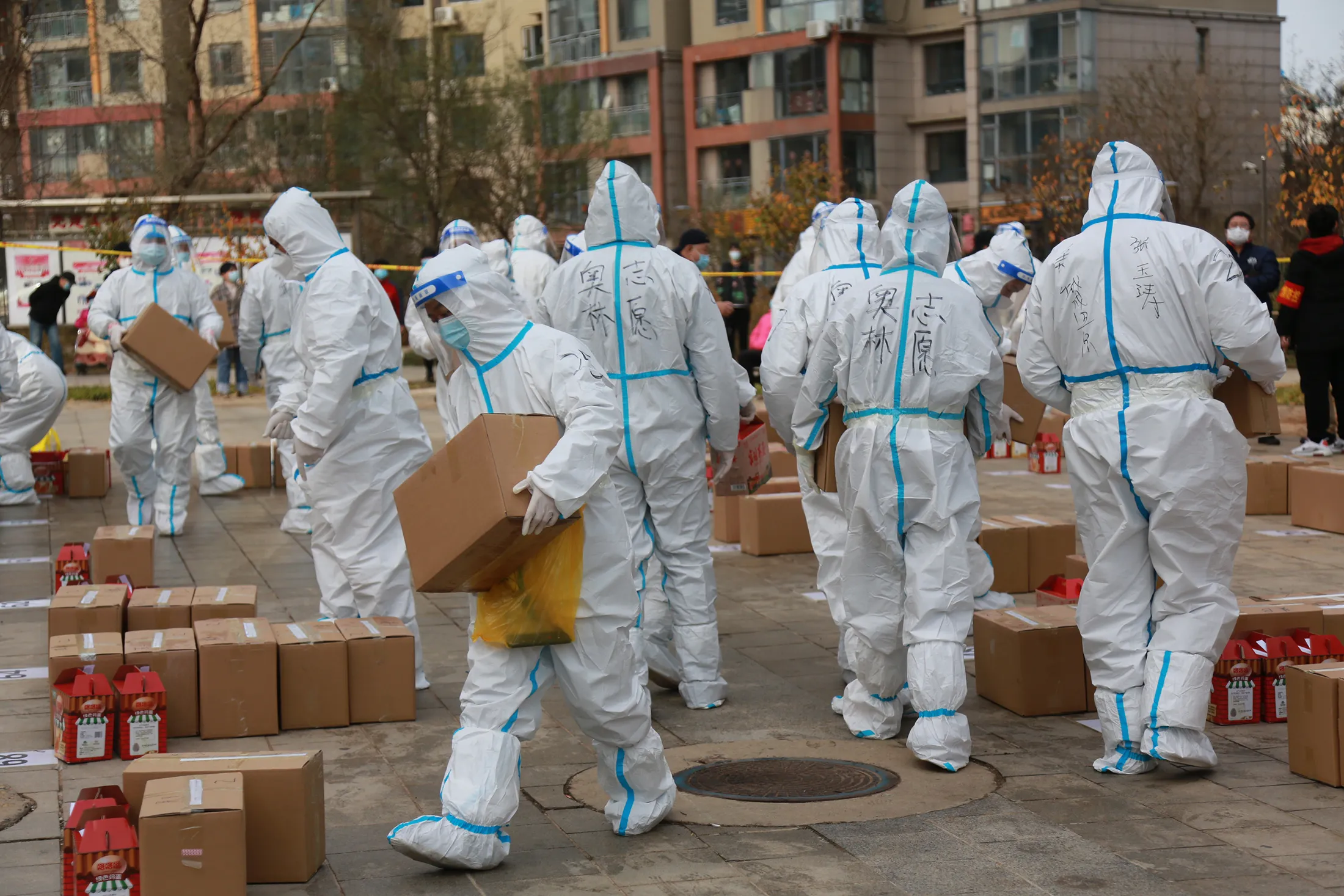 Volunteers arrange food supplies at a residential block under lockdown in Dalian, Liaoning province on Nov. 15. 