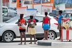 Women carry their babies and transport goods in boxes on their heads on March 26 in Luanda, Angola.