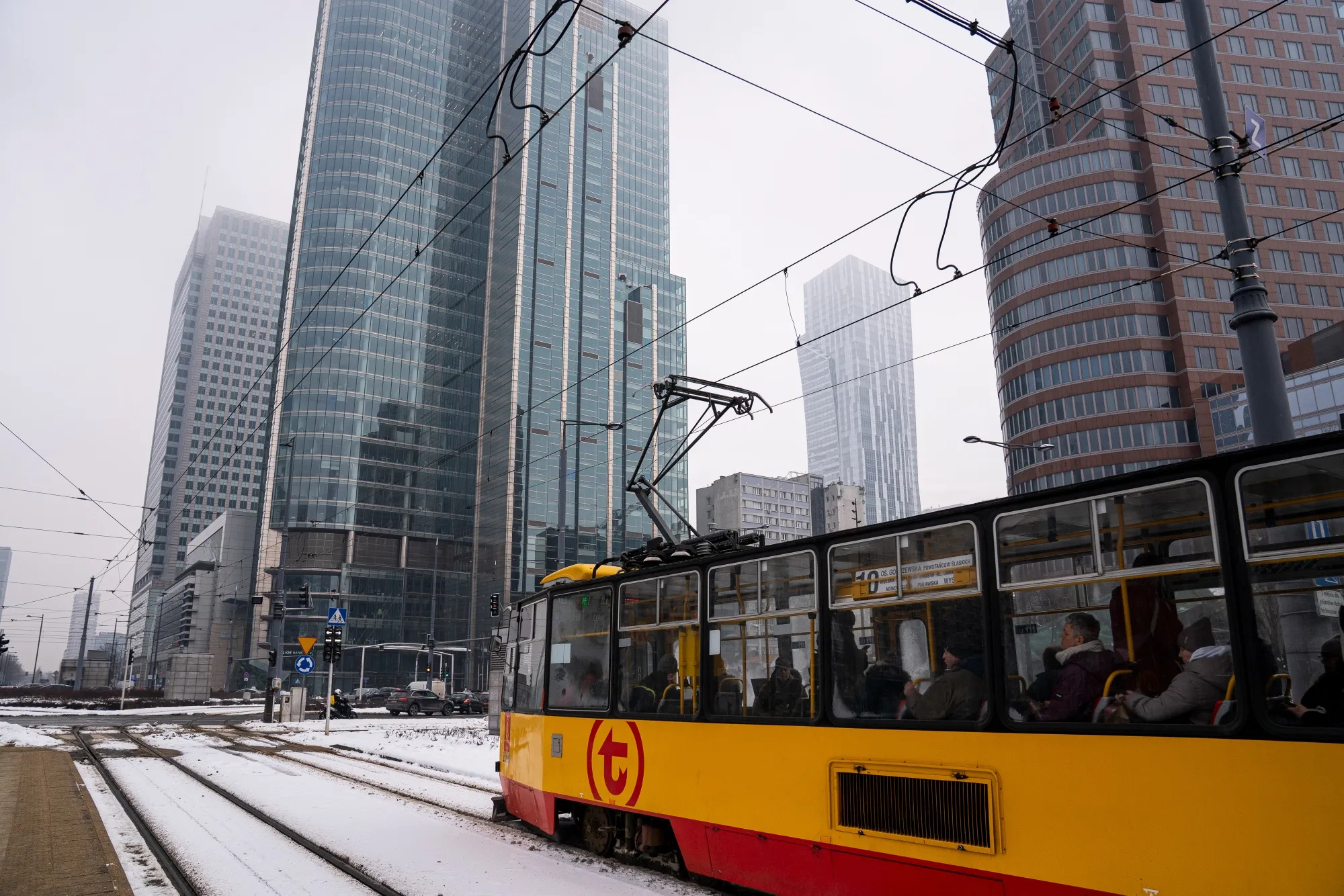 A tram travels through snow in the financial district in Warsaw.