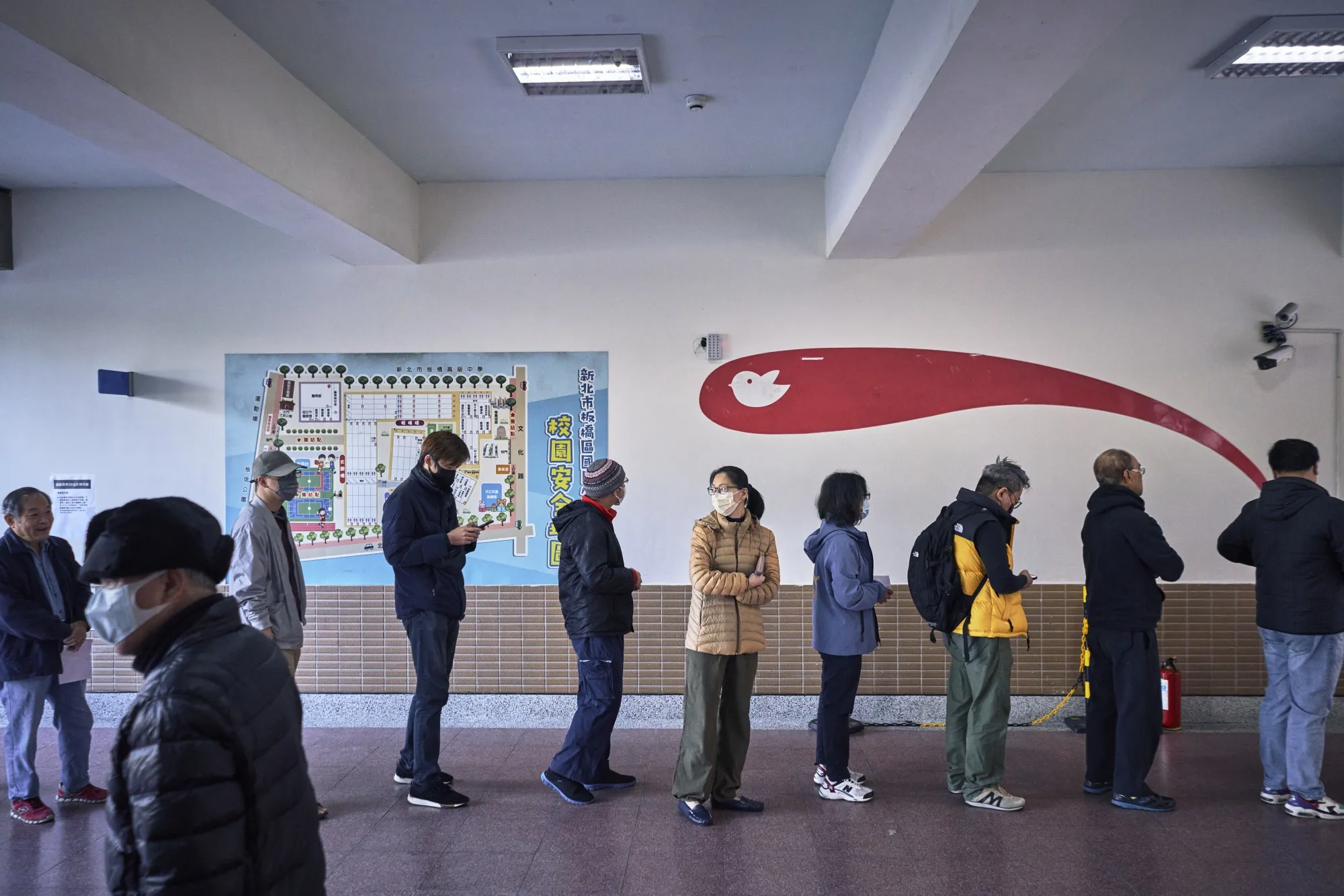 Voters stand in line at a polling station in Banqiao, New Taipei, on Jan. 13.