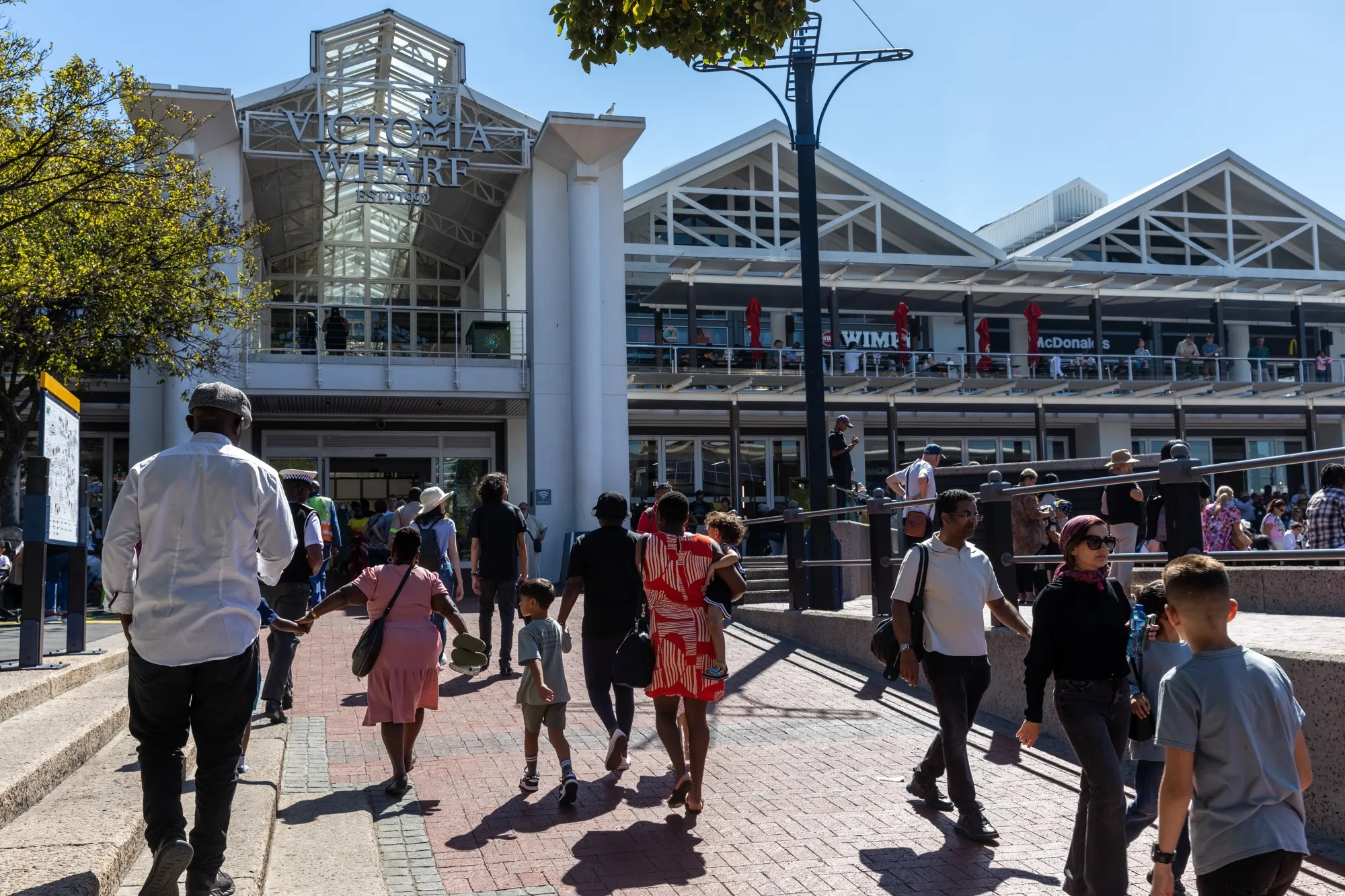 Pedestrians near the Victoria Wharf shopping mall in the Victoria & Alfred Waterfront neighborhood in Cape Town.