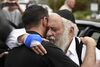 Rabbi Yisroel Goldstein, right, is hugged as he leaves a news conference at the Chabad of Poway synagogue in Poway, California on April 28, 2019. 