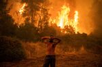 Forest fires approach the village of Pefki on Evia (Euboea) island, Greece's second largest island.