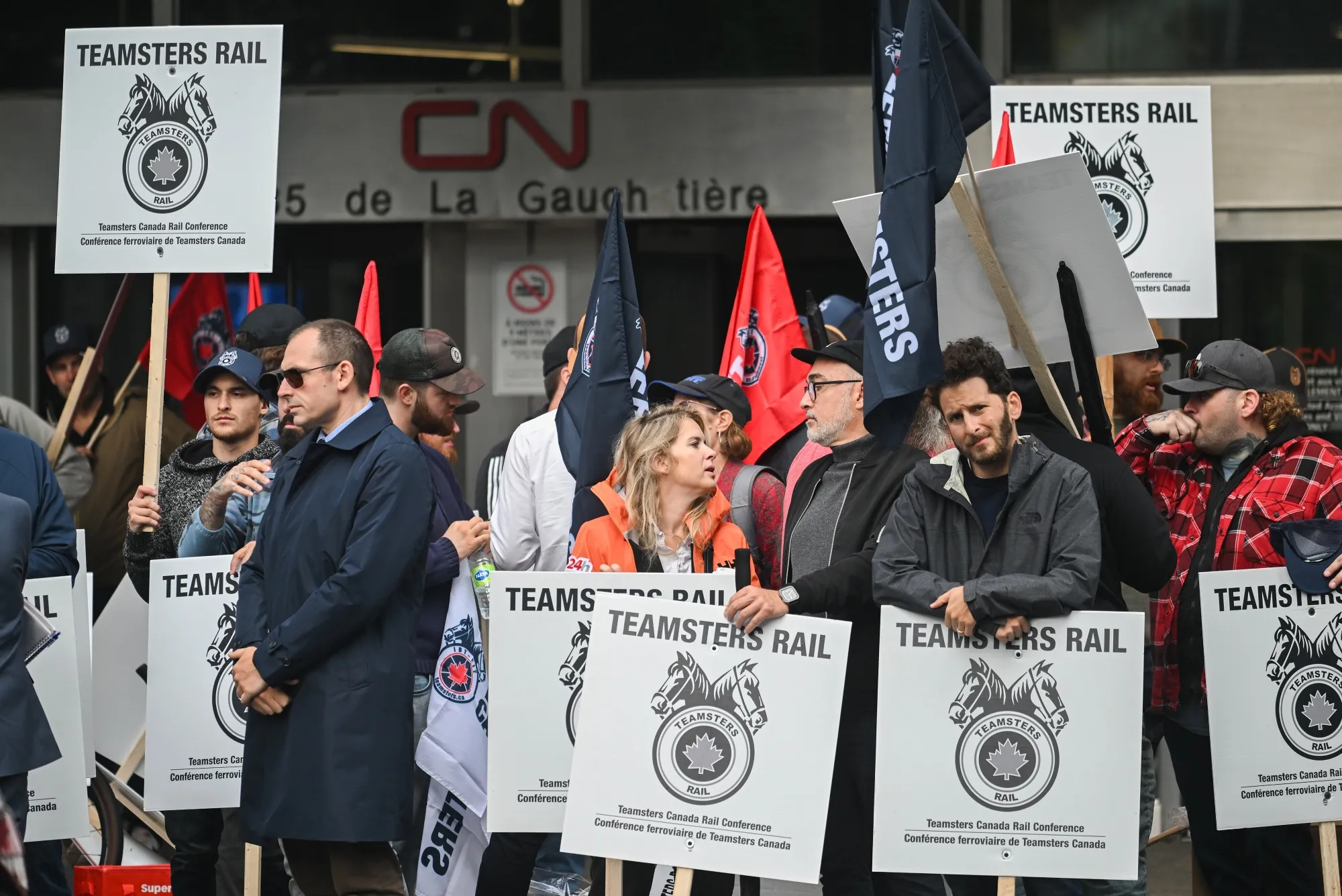Rail workers and supporters picket in front of Canadian National Railway Co. headquarters in Montreal on Thursday.