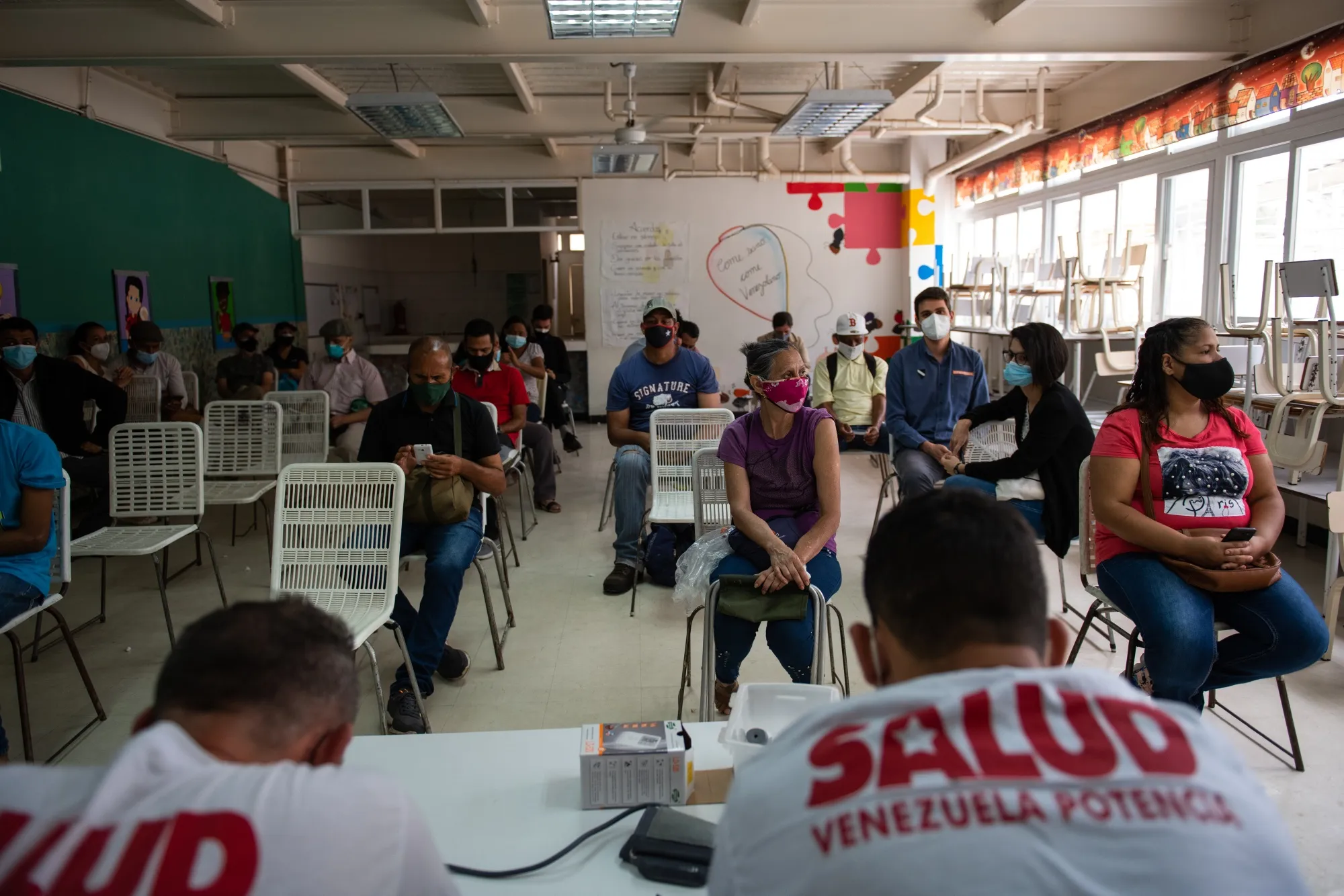 Patient sits in a waiting room after receiving their first dose of the Cuban Abdala Covid-19 vaccine in the Ciudad Tiuna neighborhood of Caracas, on July 1, 2021.