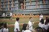 Employees and visitors walk past signage for Alibaba Group Holding Ltd. at the company\'s headquarters in Hangzhou, China.