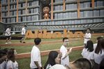 Employees and visitors walk past signage for Alibaba Group Holding Ltd. at the company\'s headquarters in Hangzhou, China.