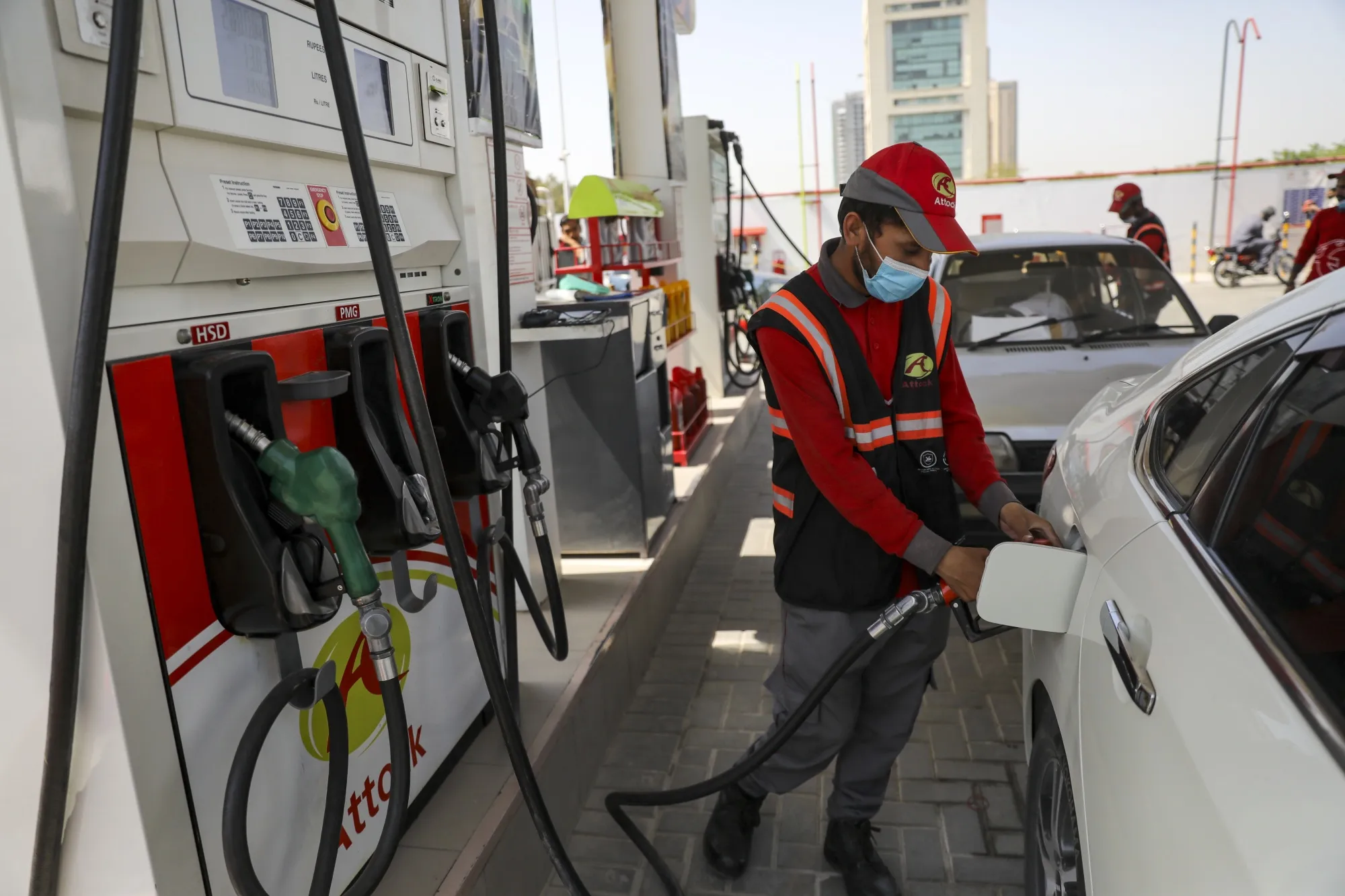 An attendant fills up a vehicle with gasoline at a&nbsp;gas station in Islamabad, Pakistan.