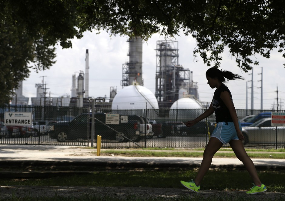 A teenage girl walks around the track of a park in the Manchester neighborhood of Houston.