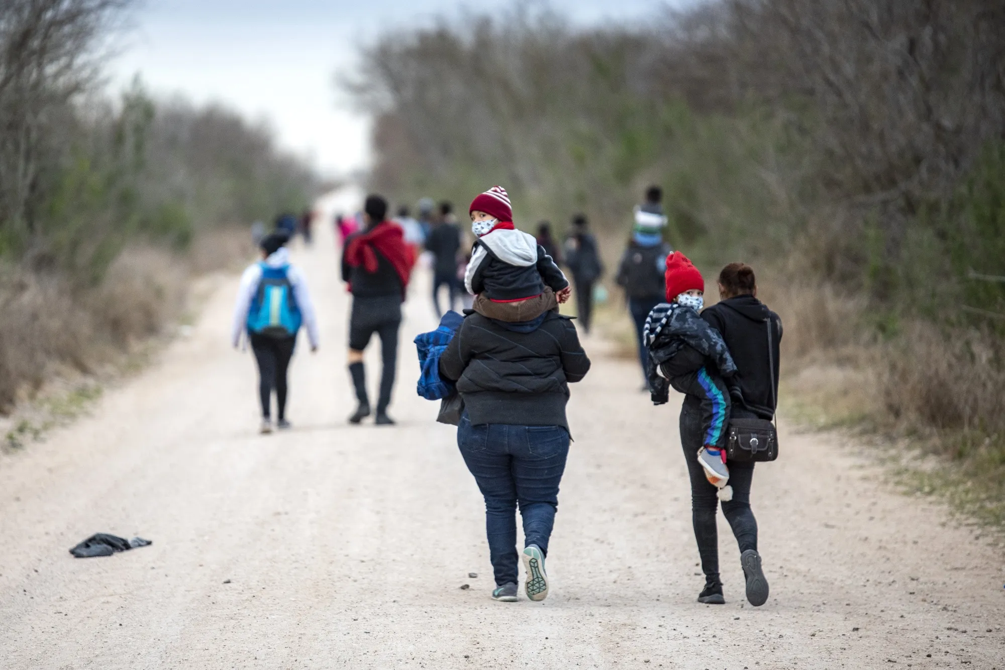 Migrant families walk toward a Customs and Border Patrol processing center near Mission, Texas, on&nbsp;March 2.&nbsp;