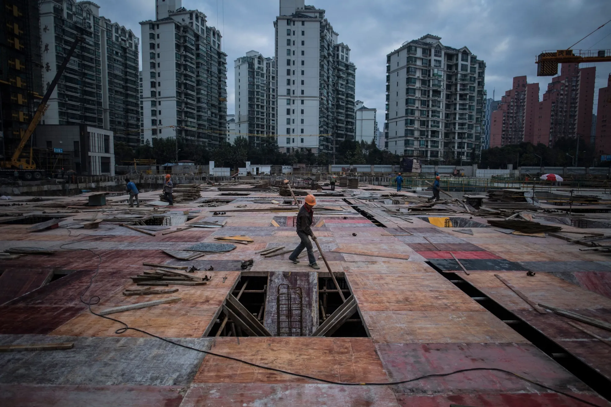 A man works at a construction site of a residential skyscraper in Shanghai.