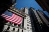 An American flag is displayed outside the New York Stock Exchange (NYSE) in New York, U.S., on Monday, July 2, 2018. U.S. stocks fell on lower than normal volume as investors waved off stronger than expected manufacturing numbers and focused on fears of increasing global trade tensions.